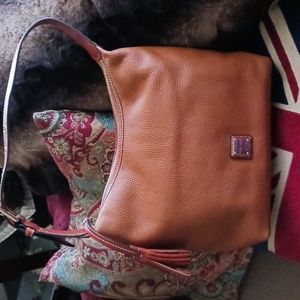 Dooney & Bourke leather bucket bag. Gold tone hardware/feet